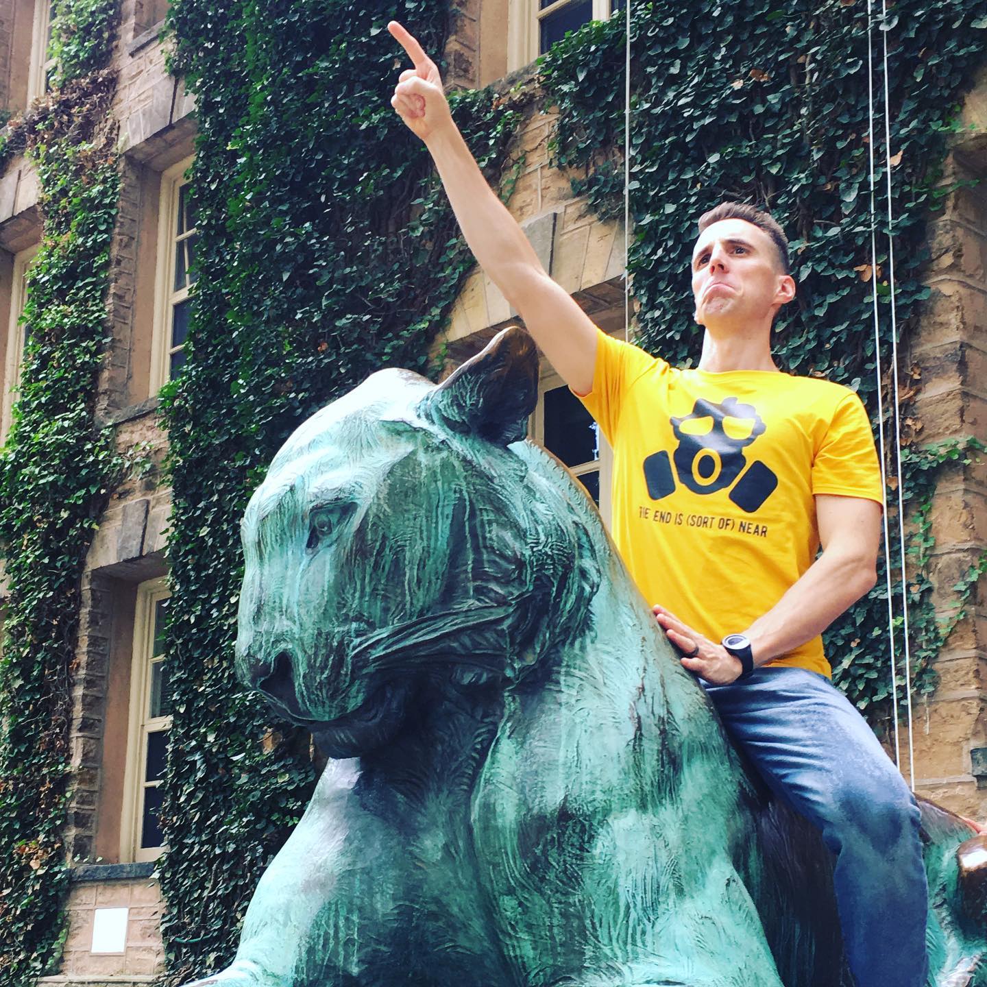 Matthew Landis on statue with book shirt