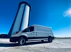 Mobile Lab Van Parked in Front of Olathe Water Tower