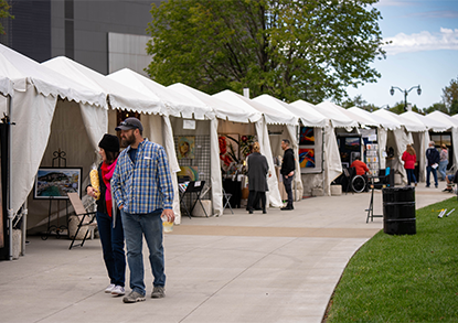 People browse art booths in the Johnson County Square for the Olathe Arts Festival