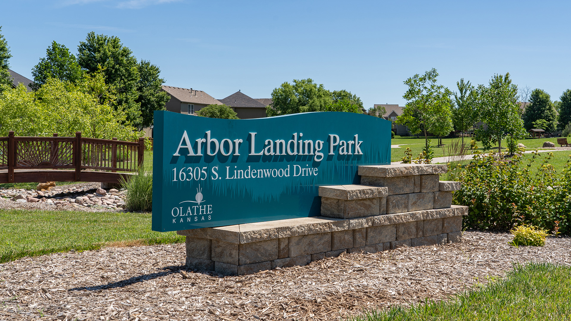 A green sign that reads: Arbor Landing Park, 16305 S. Lindenwood Dr.