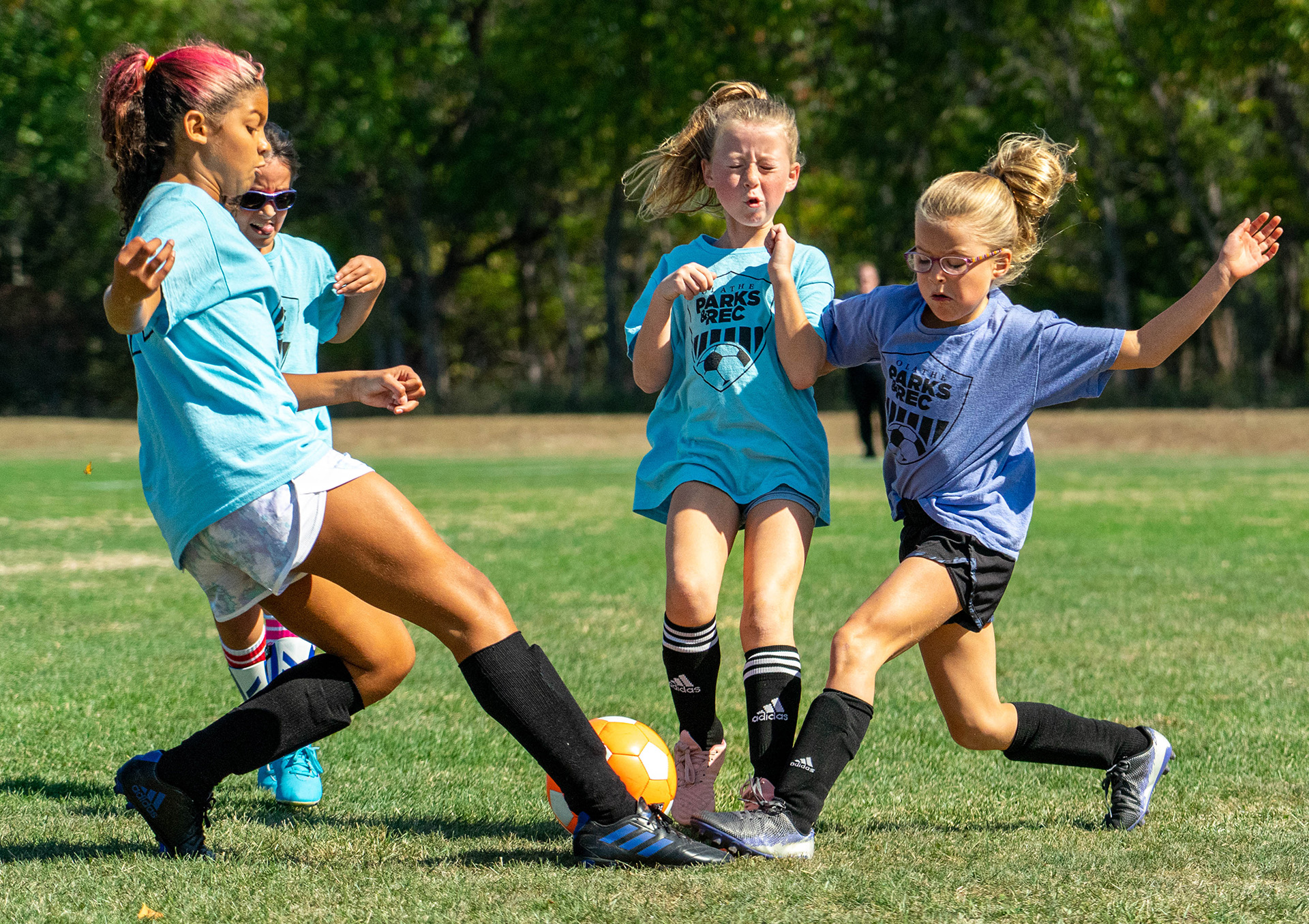 A group of girls playing soccer