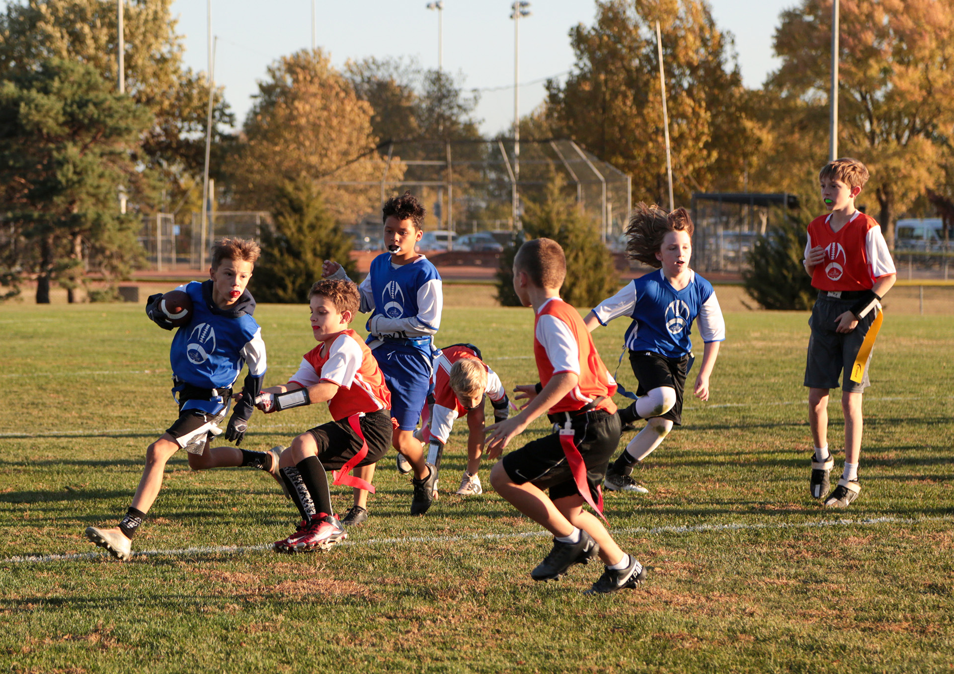 A group of boys playing flag football