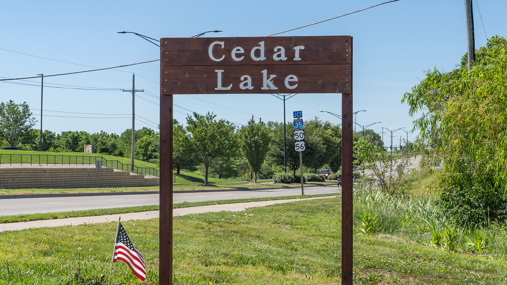 Wooden sign stating "Cedar Lake"