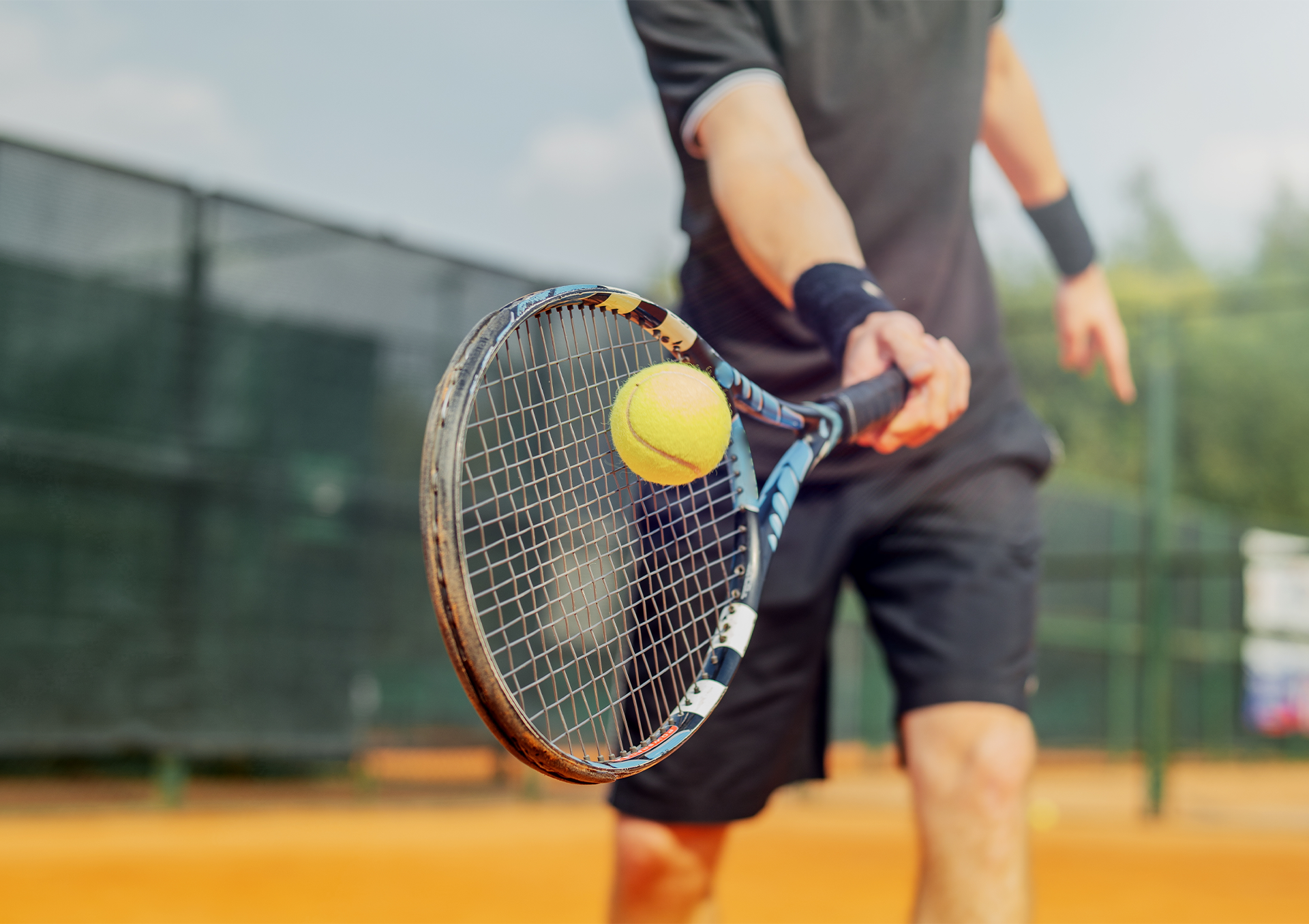 A person swinging a tennis racket