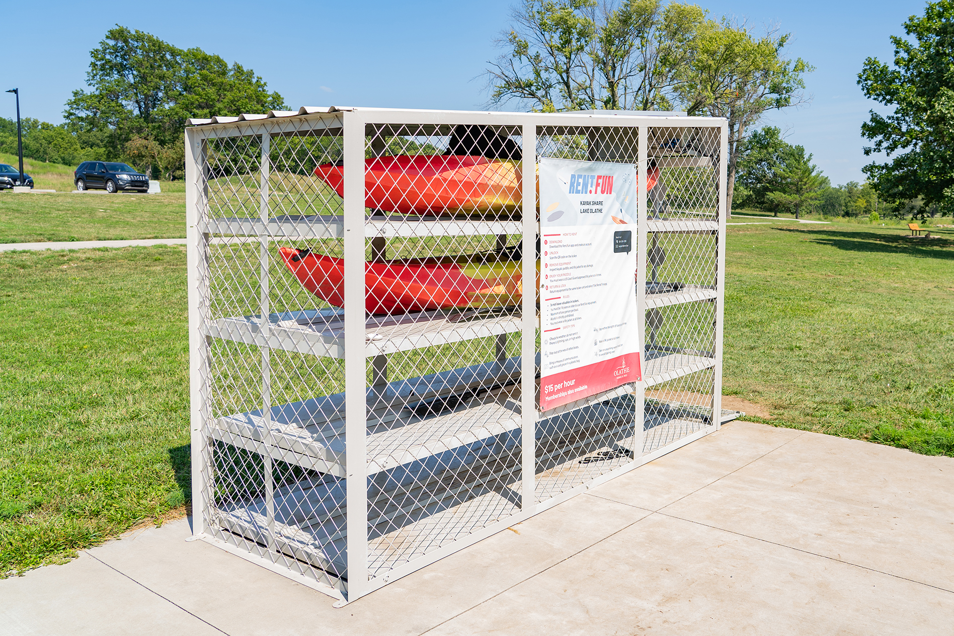 Kayak rental cage with two red and orange kayaks inside