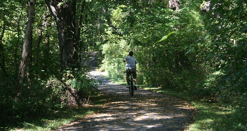 man riding a bike on a bike path