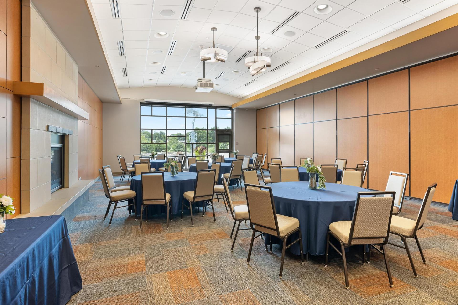 Community Room A set up with tables and chairs in a banquet style setting.