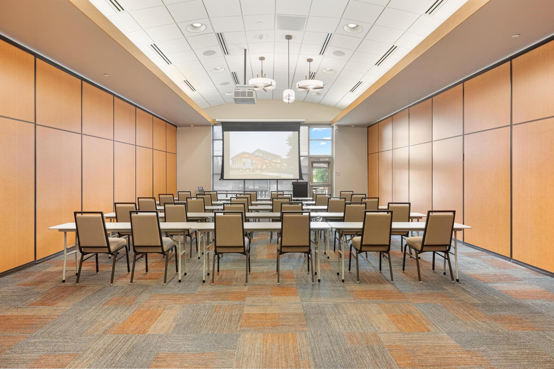 Community Room B set up with tables and chairs in a lecture style setting