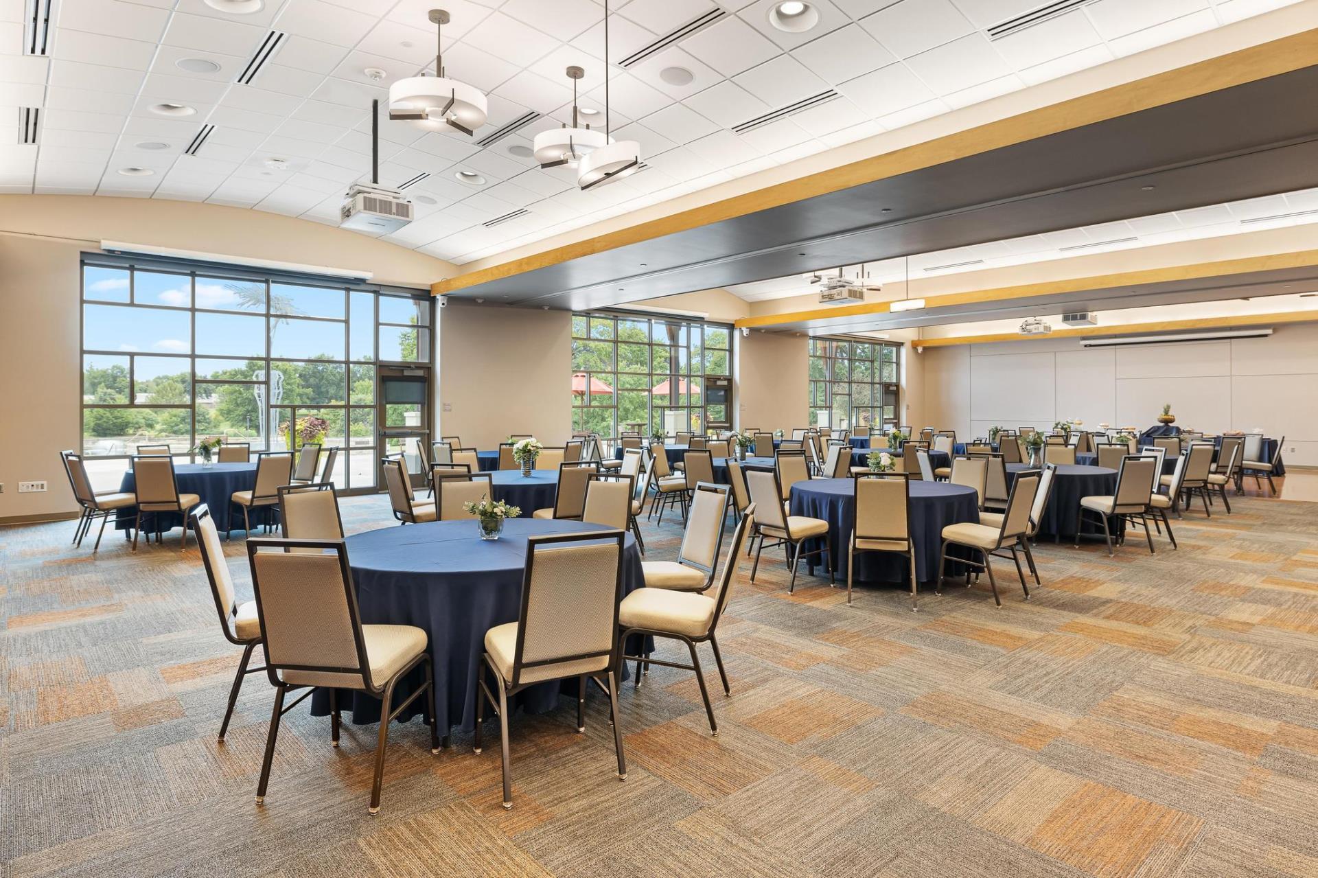 The Olathe Community Center Community Rooms set up with tables and chairs in a reception style setting.