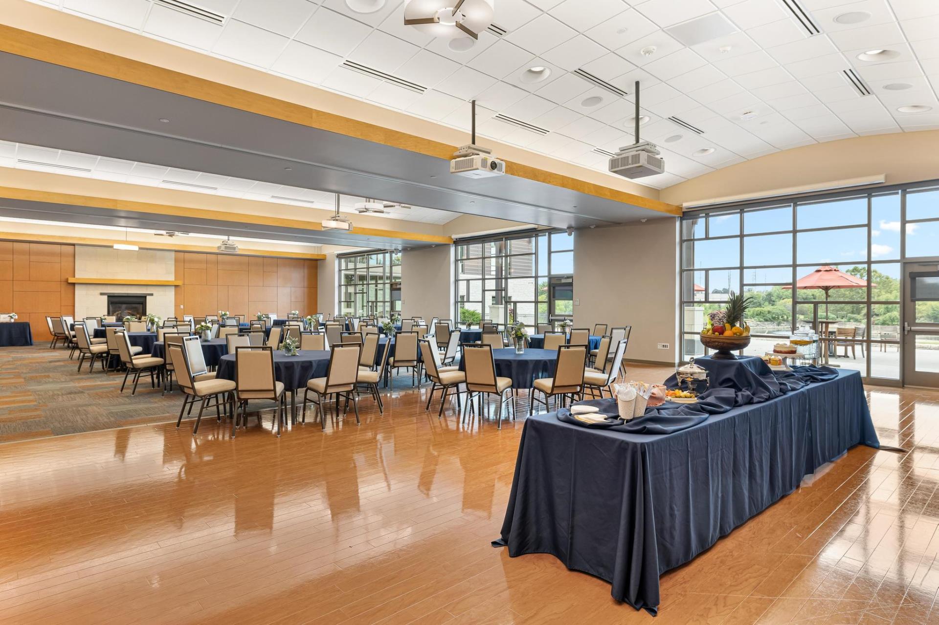 The Olathe Community Center Community Rooms set up with tables and chairs in a reception style setting.