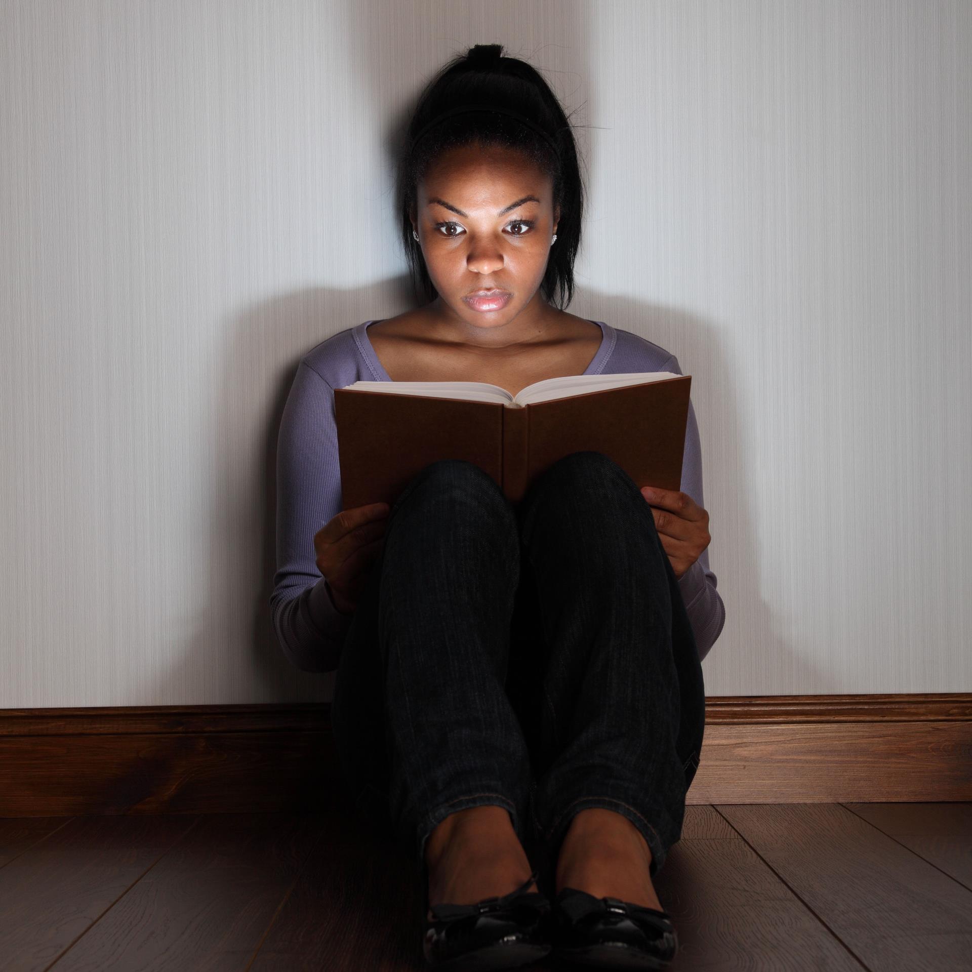 Woman reading a scary book